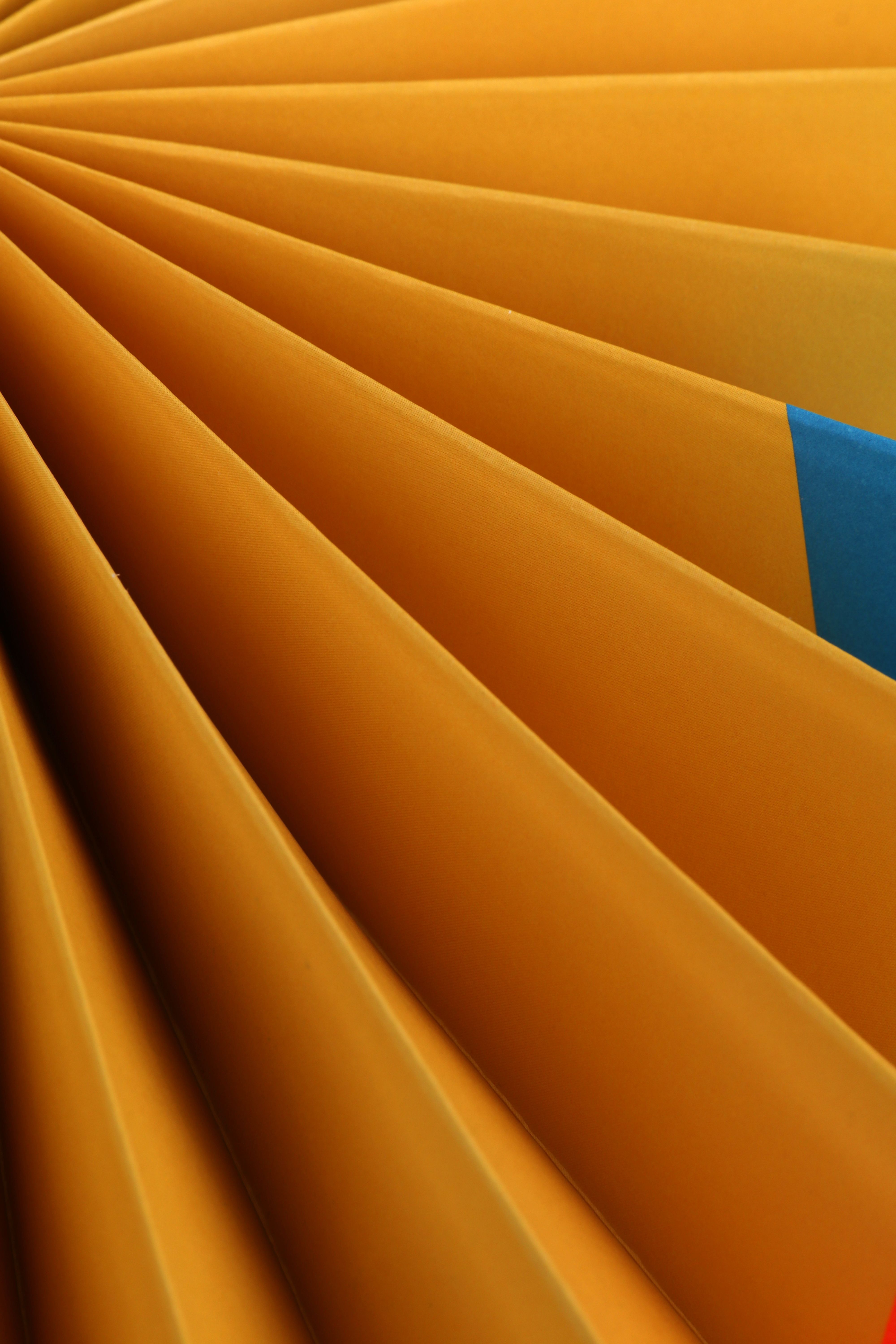 Pleated gold folds radiating from a point