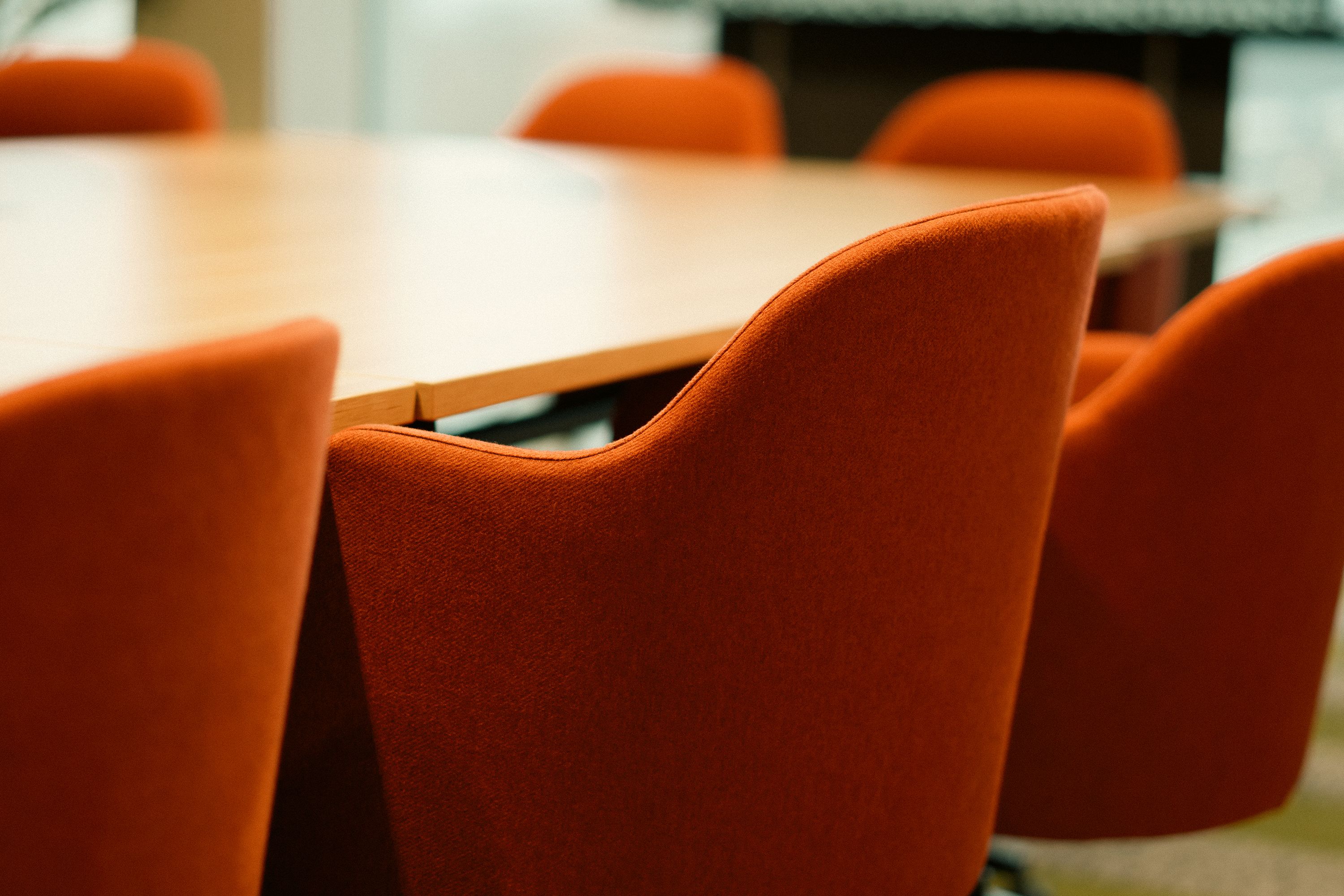 Orange chairs around a meeting table